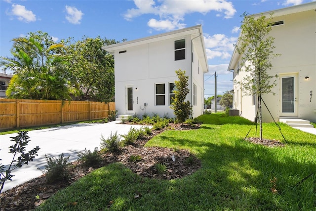 2909 W Spruce St, Tampa, FL 33607 - rear view of house featuring stucco siding and entry steps