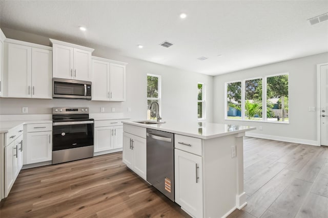 2909 W Spruce St, Tampa, FL 33607 - kitchen with stainless steel appliances, light wood-style floors, light countertops, and recessed lighting
