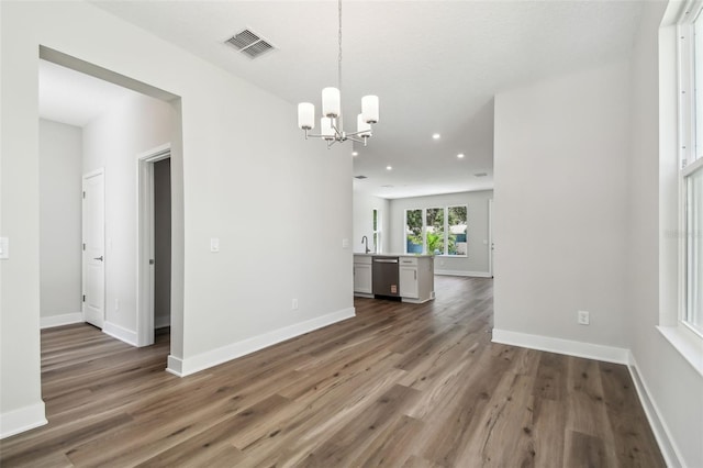 2909 W Spruce St, Tampa, FL 33607 - unfurnished dining area featuring a chandelier, wood finished floors, and recessed lighting