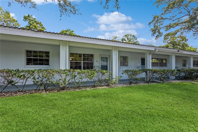 single story home with a front lawn and stucco siding