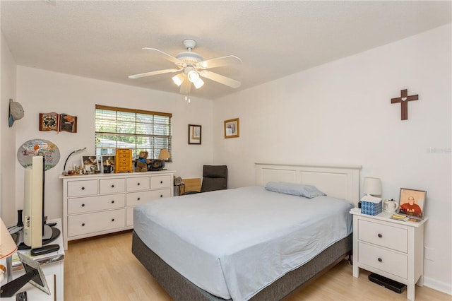 bedroom featuring a ceiling fan and light wood-style flooring