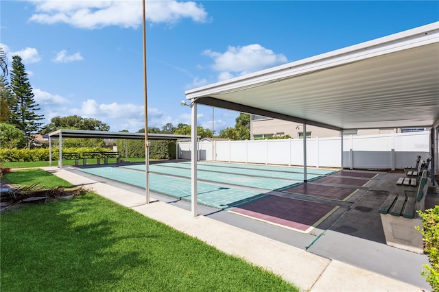 view of swimming pool featuring shuffleboard, a lawn, and fence