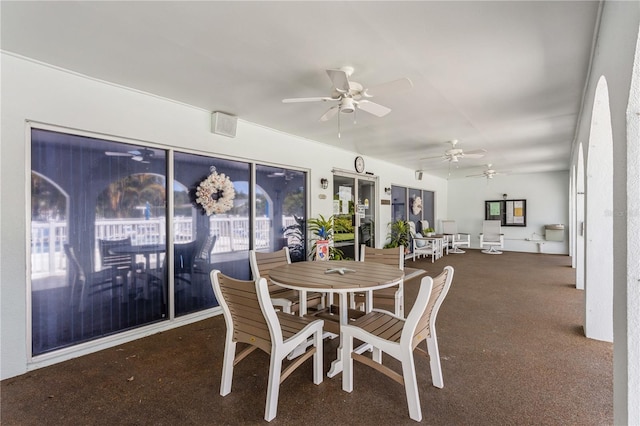 carpeted dining room featuring ceiling fan