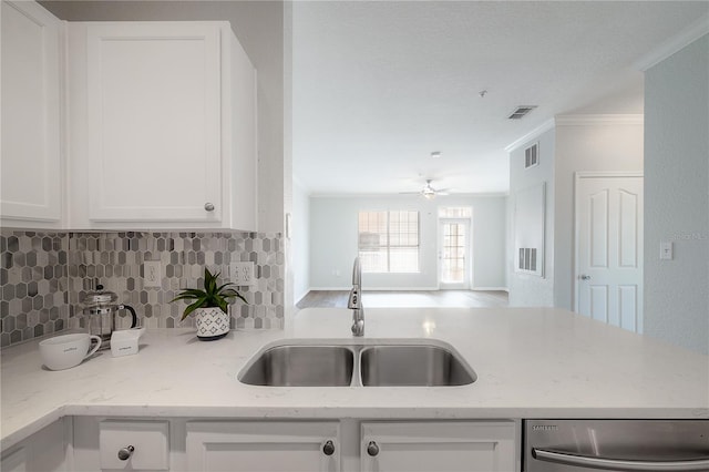 kitchen with dishwasher, crown molding, sink, light stone countertops, and white cabinetry