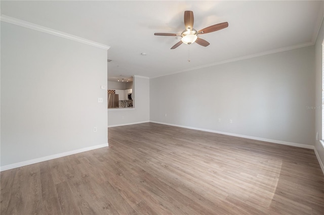 spare room featuring hardwood / wood-style floors, ceiling fan, and ornamental molding