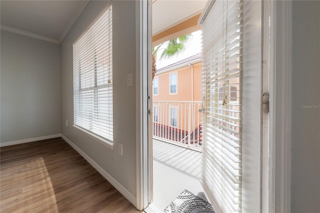 doorway to outside featuring hardwood / wood-style flooring and ornamental molding