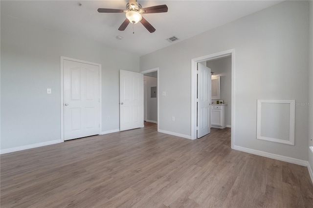 unfurnished bedroom with ceiling fan, light hardwood / wood-style floors, and ensuite bathroom