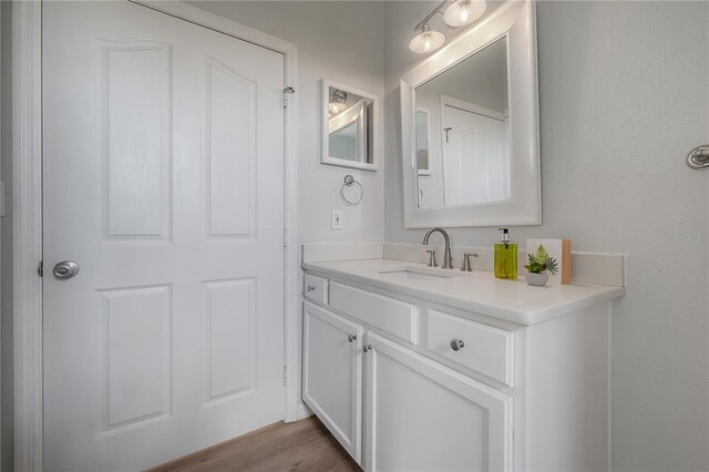 bathroom featuring vanity and wood-type flooring