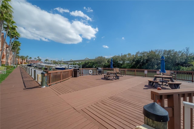 wooden deck with a grill