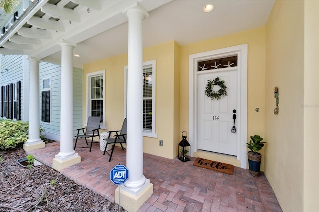 entrance to property featuring covered porch