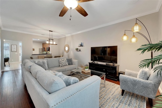 living room with ceiling fan, wood-type flooring, and ornamental molding