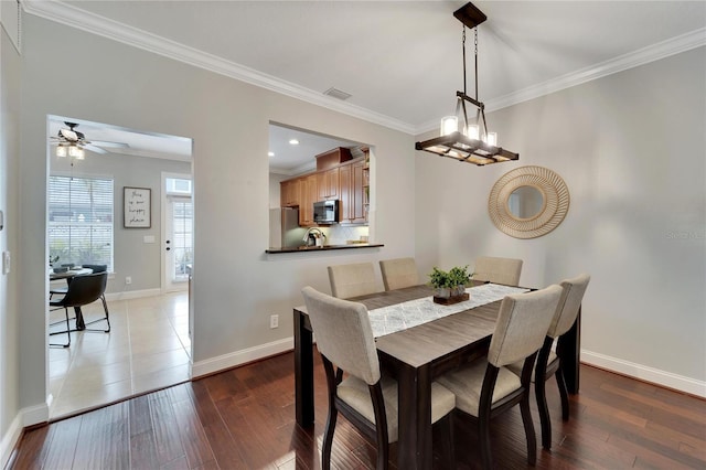 dining area featuring ceiling fan, dark hardwood / wood-style floors, and crown molding