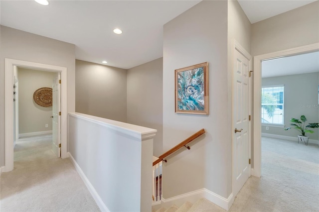 hallway with light colored carpet