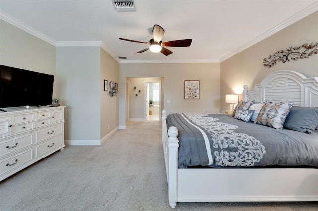 carpeted bedroom featuring ceiling fan, ensuite bath, and crown molding