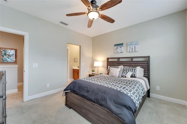 carpeted bedroom featuring ceiling fan and ensuite bathroom