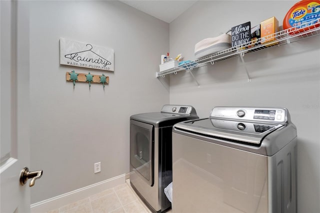 laundry room featuring light tile patterned floors and washer and dryer