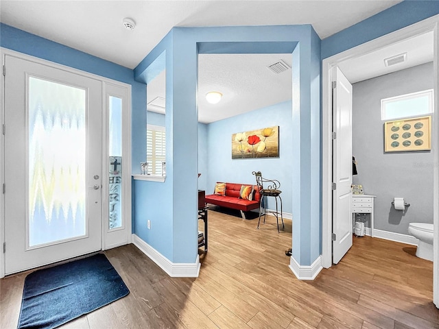 entryway featuring a wealth of natural light and light hardwood / wood-style flooring