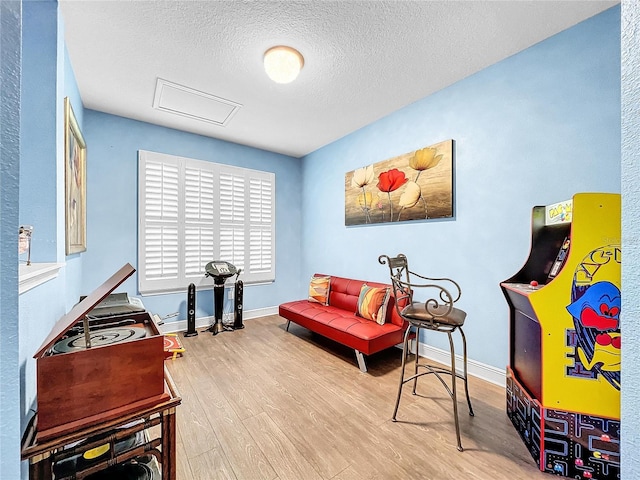 sitting room featuring wood-type flooring and a textured ceiling