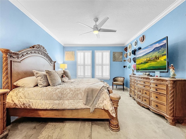 bedroom featuring ceiling fan, ornamental molding, a textured ceiling, and carpet floors