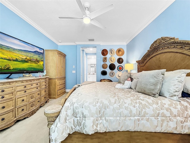 carpeted bedroom with ceiling fan and ornamental molding