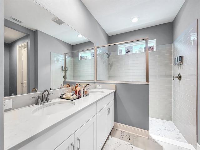 bathroom with vanity and tiled shower