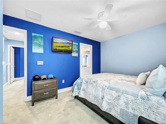 carpeted bedroom featuring ceiling fan, a textured ceiling, and connected bathroom