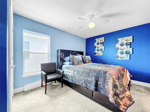 carpeted bedroom with a textured ceiling and ceiling fan