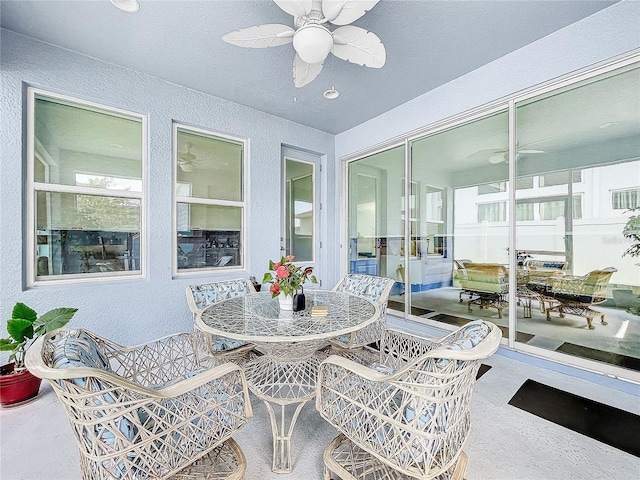 sunroom featuring ceiling fan