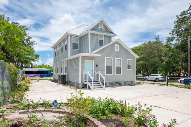 rear view of property with central AC unit