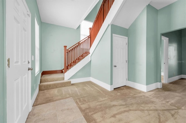 interior space with carpet and baseboards