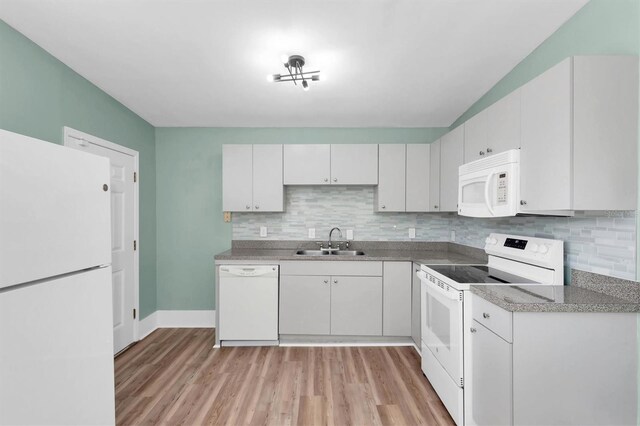 kitchen featuring sink, white appliances, light hardwood / wood-style floors, and white cabinets