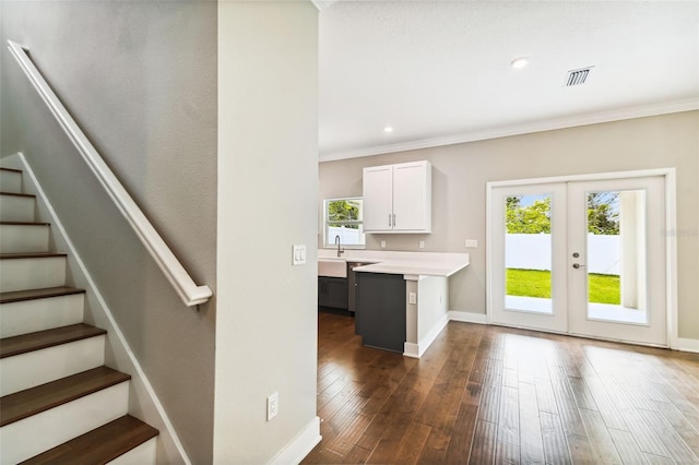 kitchen with dark wood-style floors, light countertops, visible vents, and plenty of natural light