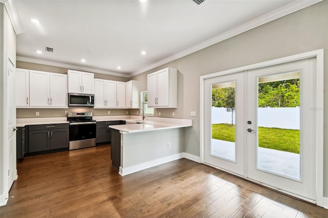 kitchen featuring white cabinets, dark wood-type flooring, stainless steel appliances, and french doors