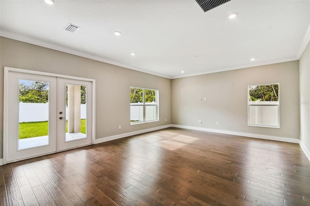 empty room with visible vents, baseboards, dark wood-style flooring, and french doors