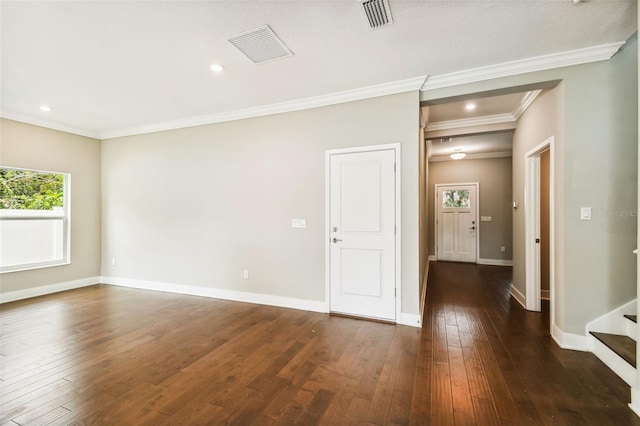 spare room with dark hardwood / wood-style flooring and crown molding