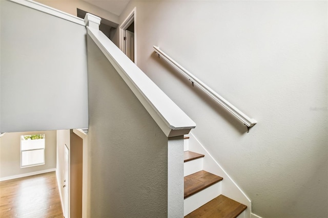 stairs with baseboards and wood finished floors