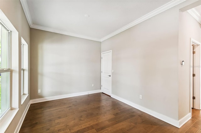 unfurnished room featuring dark wood-type flooring and ornamental molding