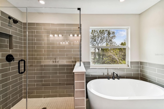 bathroom featuring shower with separate bathtub