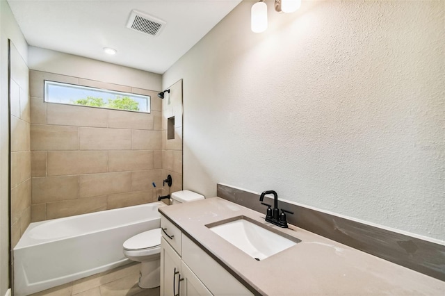 full bathroom featuring tile patterned floors, vanity, toilet, and tiled shower / bath combo