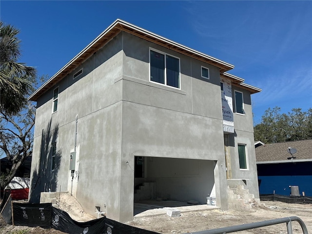 view of front of home with an attached garage and stucco siding