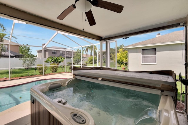 view of pool featuring glass enclosure and ceiling fan