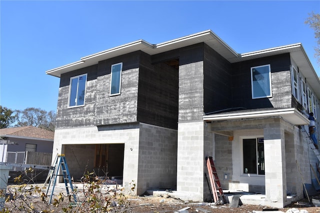 view of front of property featuring a garage and fence