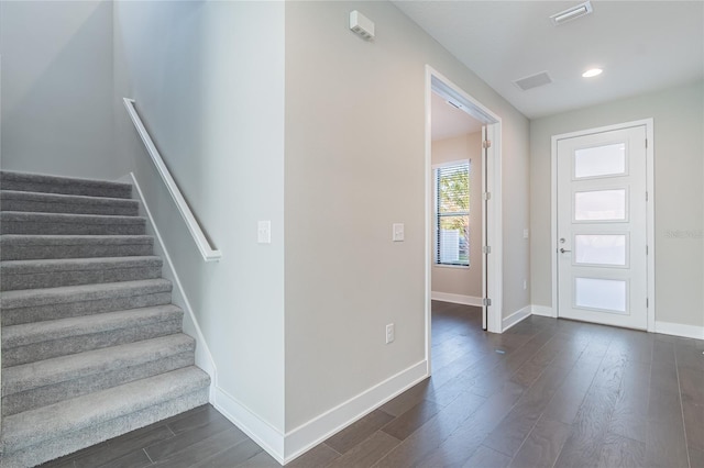 entryway featuring recessed lighting, visible vents, baseboards, stairway, and dark wood finished floors