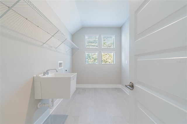 washroom featuring hookup for a washing machine, laundry area, a sink, baseboards, and electric dryer hookup