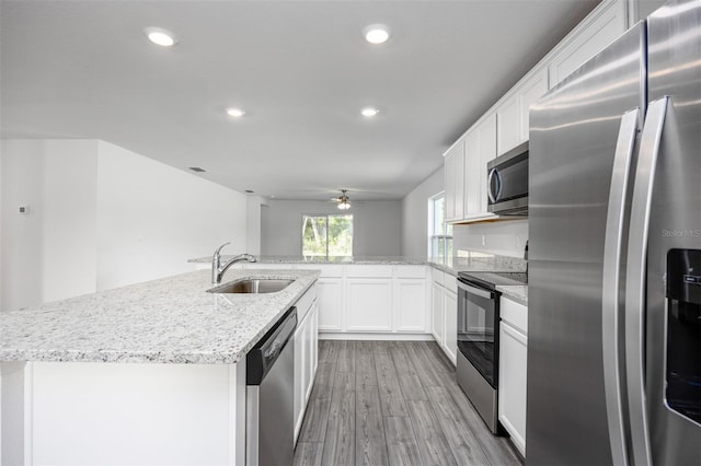 kitchen featuring white cabinetry, sink, an island with sink, and stainless steel appliances