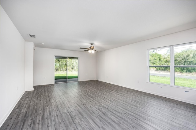 spare room with ceiling fan and dark wood-type flooring