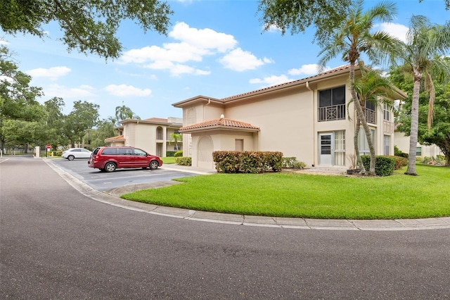 mediterranean / spanish-style home featuring a front lawn