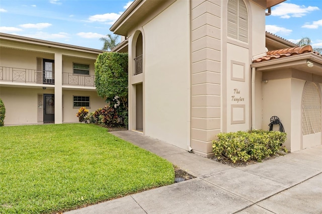 view of property exterior with a yard