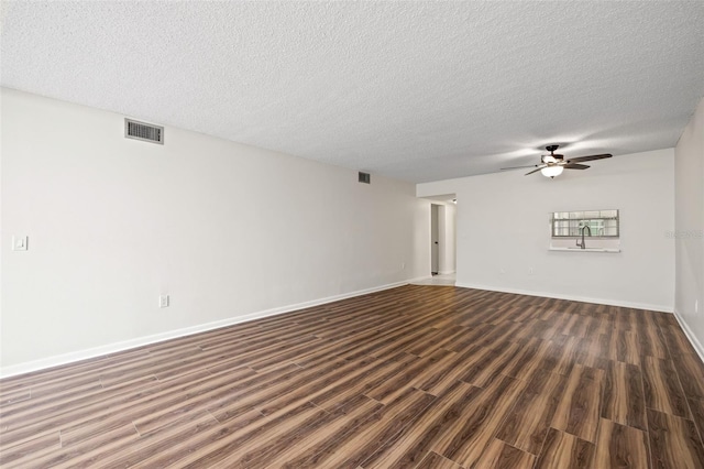 unfurnished living room with ceiling fan, dark hardwood / wood-style floors, and a textured ceiling