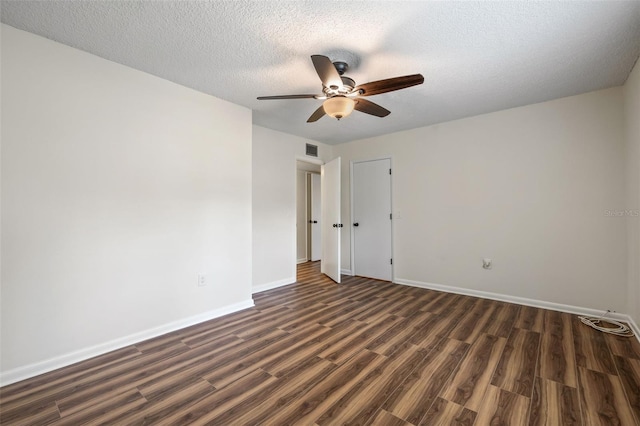 unfurnished room with ceiling fan, dark hardwood / wood-style floors, and a textured ceiling